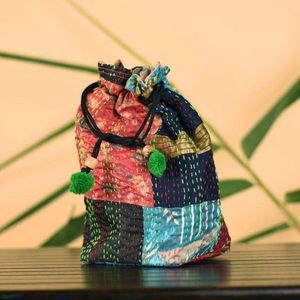Colourful Potli in traditional Kantha patchwork on silk exteriors